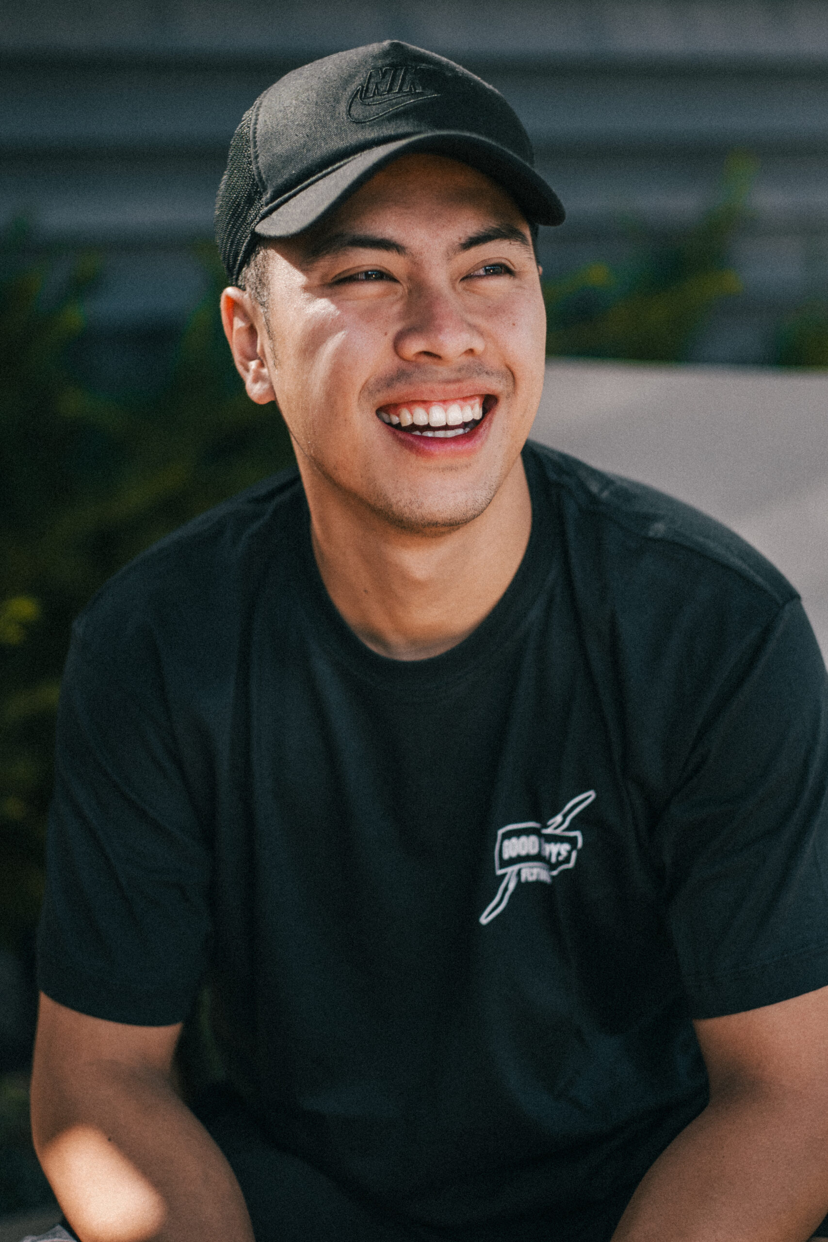 Portrait of a smiling man wearing a black cap and shirt